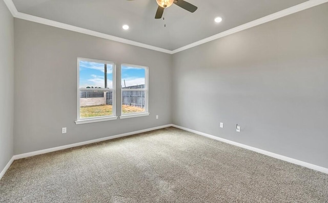 carpeted empty room with ceiling fan and ornamental molding