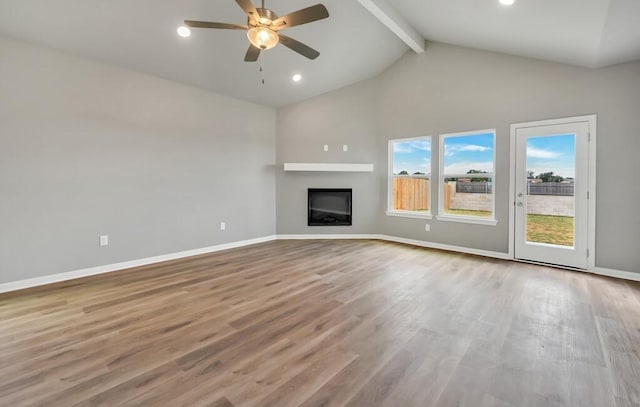 unfurnished living room with beam ceiling, light hardwood / wood-style floors, high vaulted ceiling, and ceiling fan