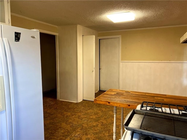 interior space with crown molding and a textured ceiling