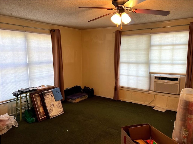 misc room featuring ceiling fan, cooling unit, dark carpet, and a textured ceiling