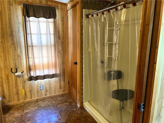 bathroom with a shower with curtain and wooden walls