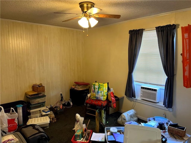 miscellaneous room with ceiling fan, cooling unit, ornamental molding, and a textured ceiling