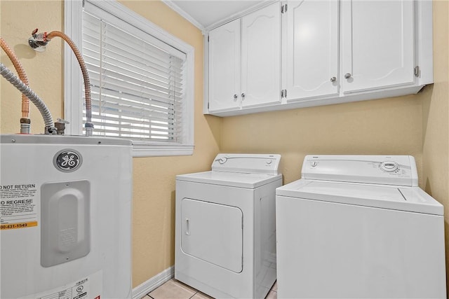 washroom with washer and dryer, cabinets, light tile patterned floors, and water heater