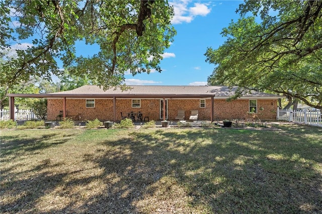 back of property featuring a yard and a patio