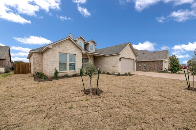 view of front of property with a front yard and a garage