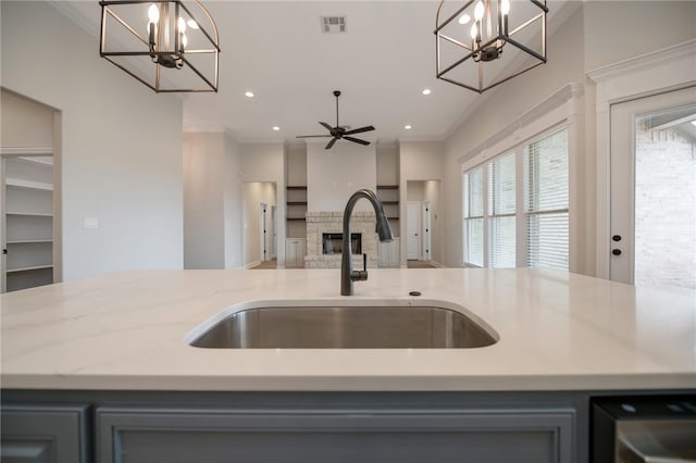 kitchen featuring sink, an island with sink, and hanging light fixtures