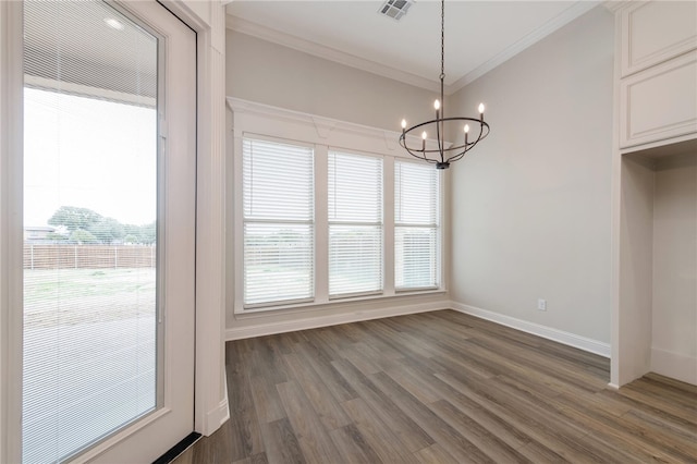 unfurnished dining area featuring a chandelier, dark wood-type flooring, and crown molding