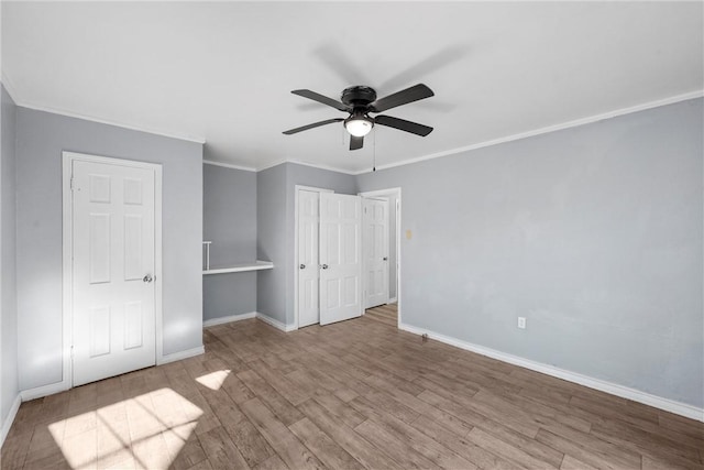 unfurnished bedroom featuring crown molding, ceiling fan, and light hardwood / wood-style flooring