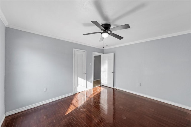 empty room featuring dark wood-type flooring, ceiling fan, and ornamental molding