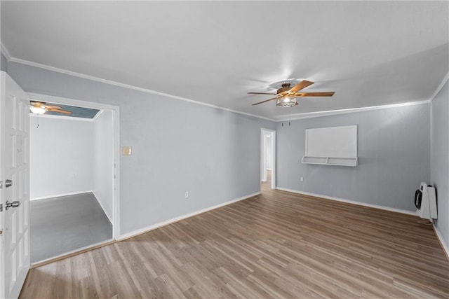 unfurnished room featuring ornamental molding, heating unit, hardwood / wood-style floors, and ceiling fan