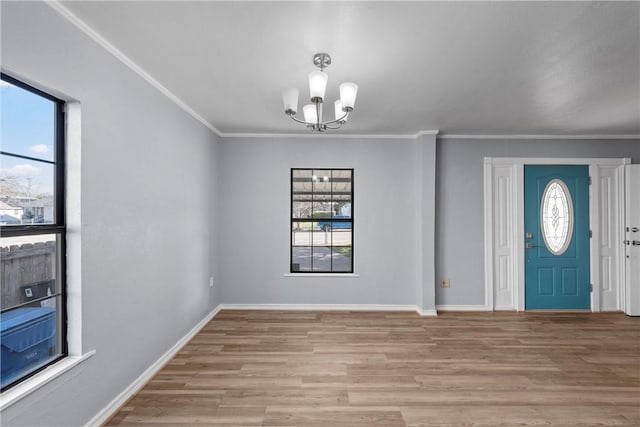 entrance foyer with light hardwood / wood-style flooring, a wealth of natural light, and a chandelier