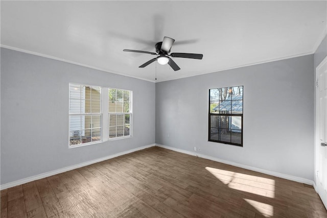 unfurnished room with dark wood-type flooring, ornamental molding, and ceiling fan