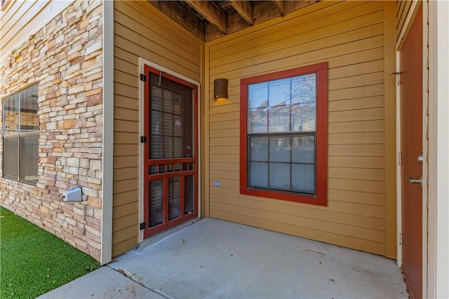 view of exterior entry with brick siding