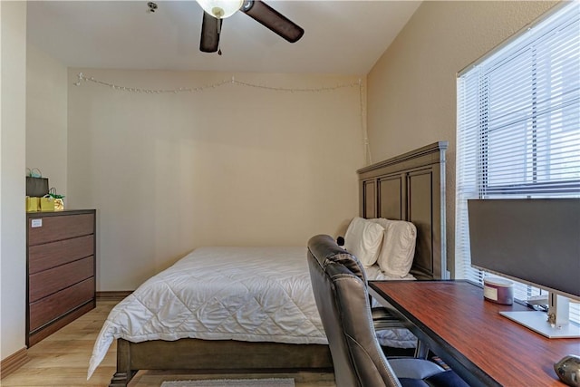 bedroom with a ceiling fan and light wood-style floors