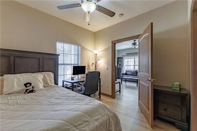 bedroom with light wood-style flooring and ceiling fan