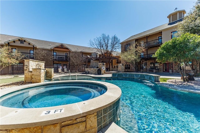 community pool featuring a community hot tub and fence