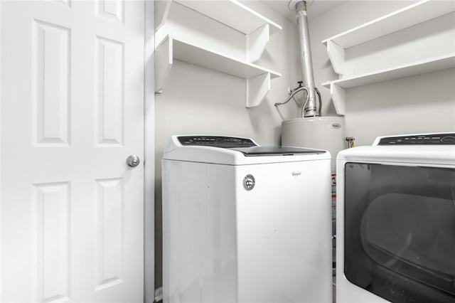 laundry area with washing machine and clothes dryer and laundry area