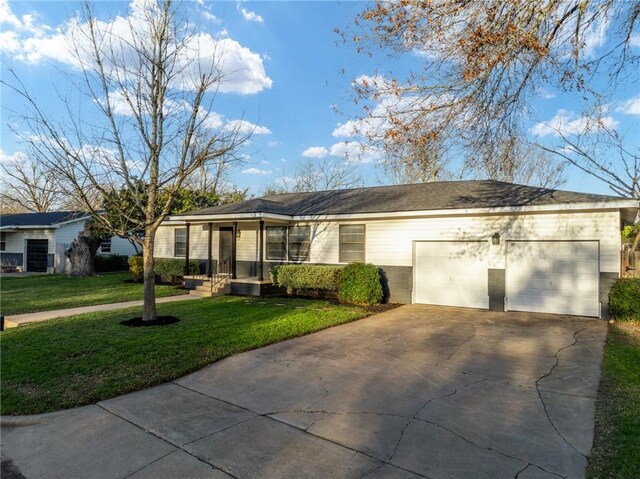 ranch-style house featuring an attached garage, concrete driveway, and a front lawn