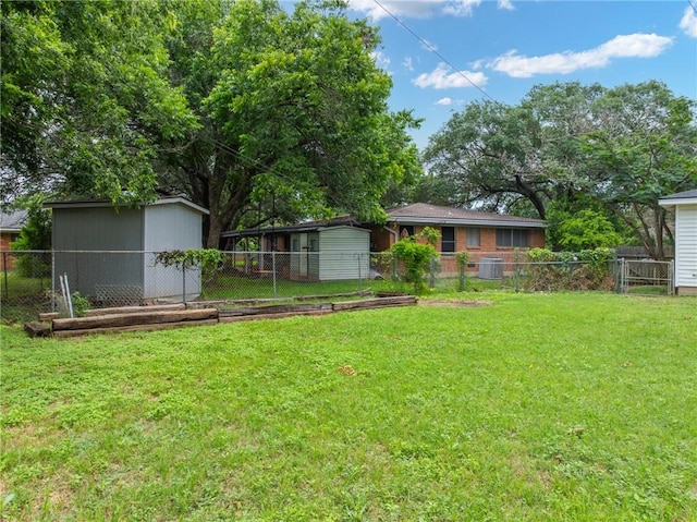 view of yard featuring a storage shed, cooling unit, fence, and an outdoor structure