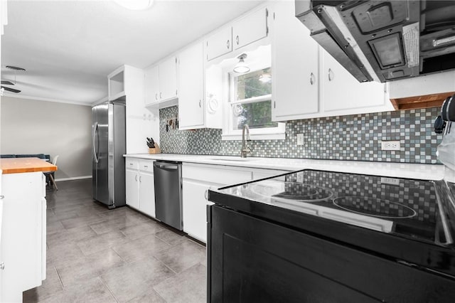 kitchen with light countertops, white cabinets, tasteful backsplash, and appliances with stainless steel finishes