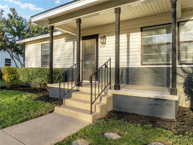 view of exterior entry with a porch