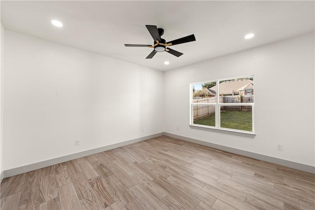 spare room featuring light hardwood / wood-style flooring and ceiling fan