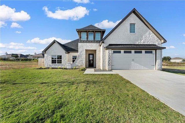 view of front of property with a garage and a front lawn