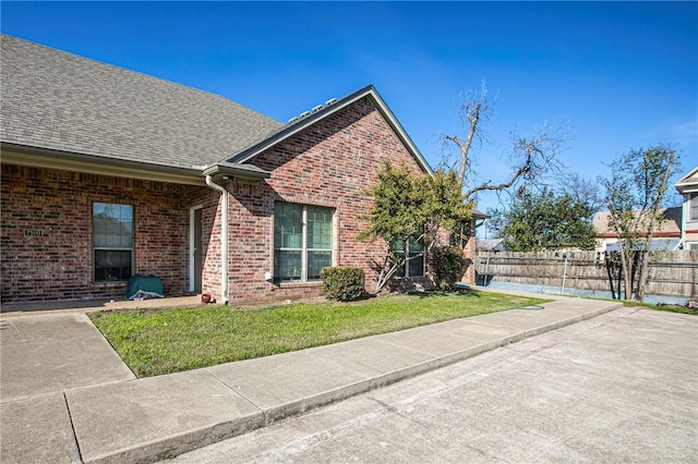 view of side of property with a lawn