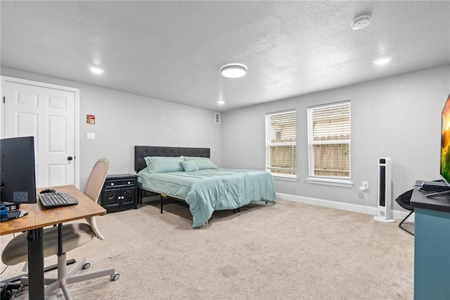 carpeted bedroom featuring a textured ceiling