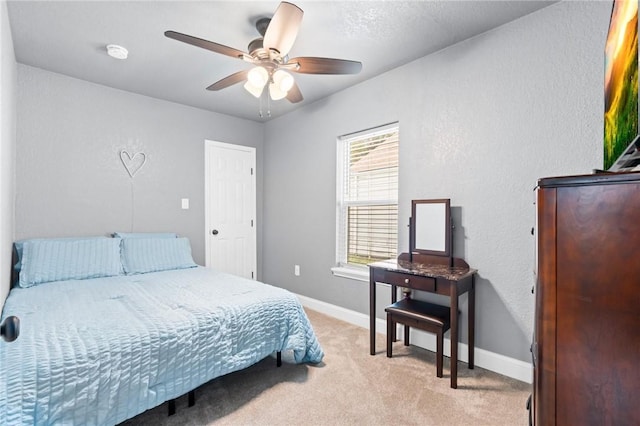 bedroom featuring light colored carpet and ceiling fan