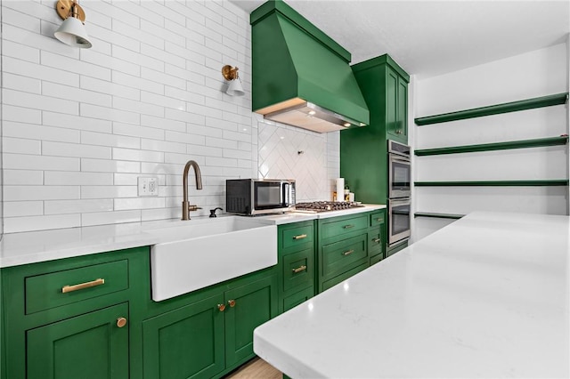 kitchen with sink, custom range hood, and green cabinetry