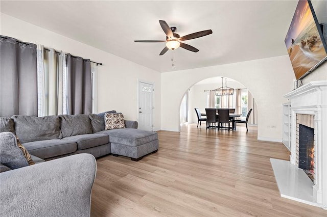 living room with ceiling fan and light hardwood / wood-style floors