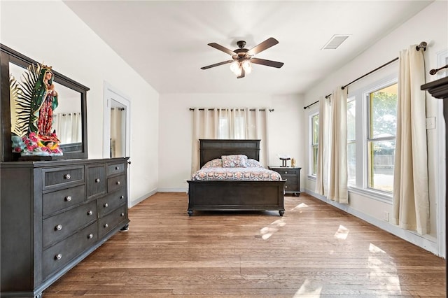 bedroom with ceiling fan and light hardwood / wood-style flooring