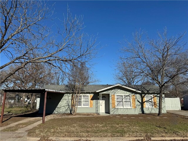 single story home with a carport and a front lawn