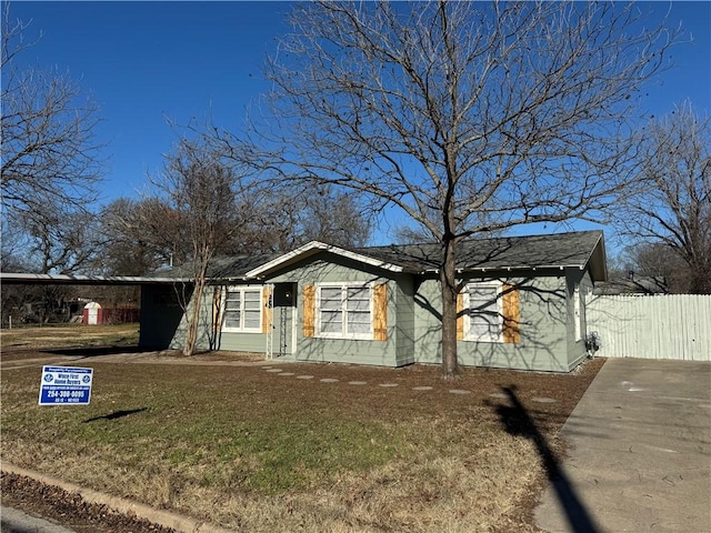 single story home featuring a front lawn and a carport