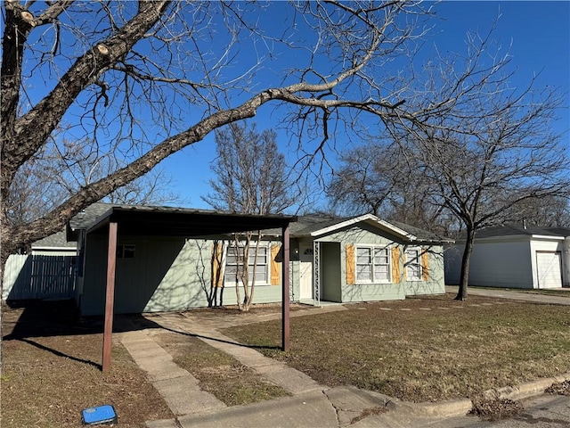 single story home featuring a carport and a front yard