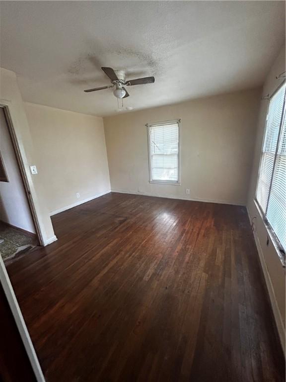 spare room featuring ceiling fan and dark hardwood / wood-style flooring