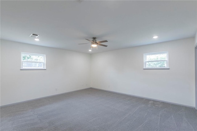 empty room featuring carpet flooring, plenty of natural light, and ceiling fan