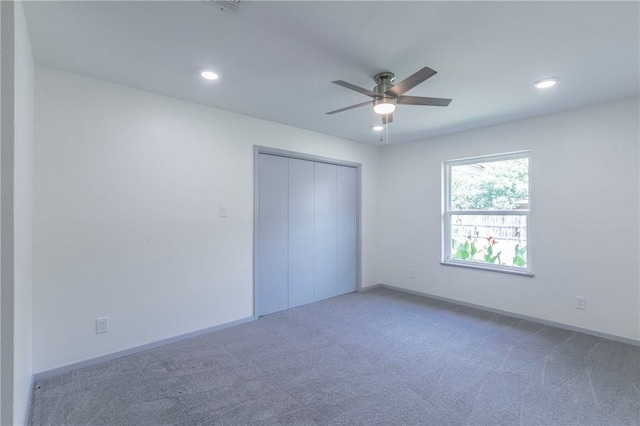 unfurnished bedroom with carpet flooring, a closet, and ceiling fan