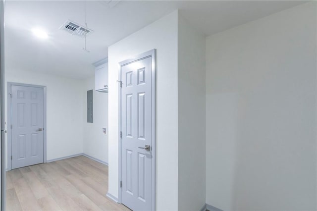 hallway featuring light hardwood / wood-style floors and electric panel