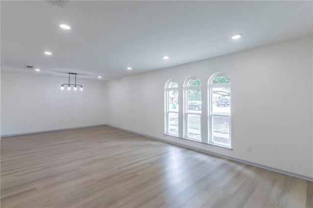 unfurnished room featuring a healthy amount of sunlight and light hardwood / wood-style floors