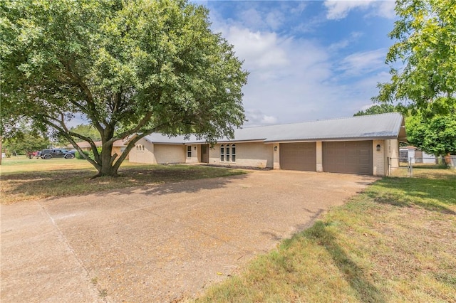 single story home with a garage and a front lawn