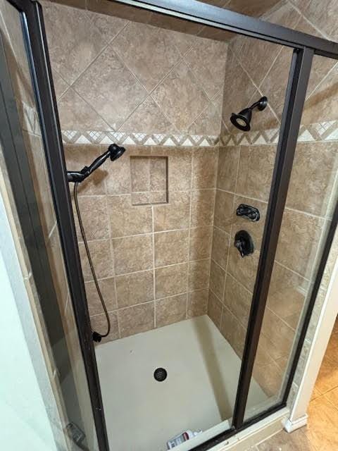 bathroom with a shower with door