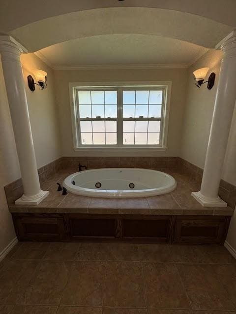 bathroom with tile patterned flooring, a bathtub, and crown molding