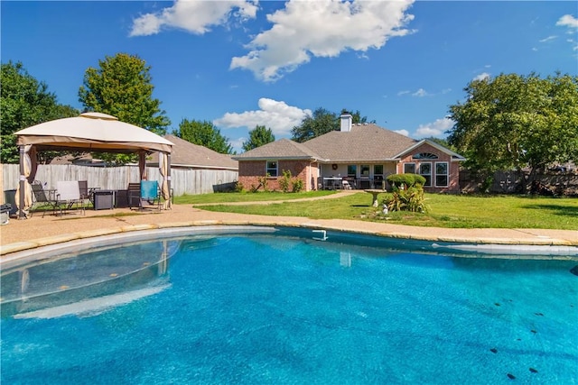 view of pool with a gazebo and a lawn