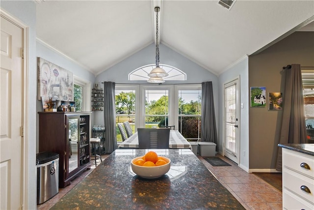 dining space with lofted ceiling with beams, tile patterned floors, ceiling fan, and ornamental molding