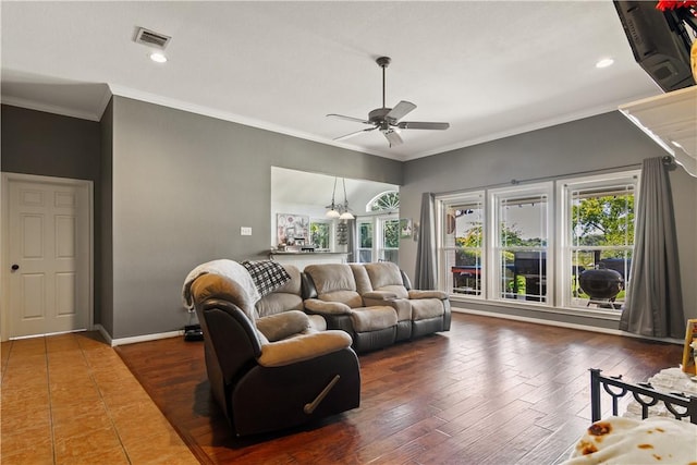 living room featuring ceiling fan with notable chandelier, dark hardwood / wood-style floors, and ornamental molding