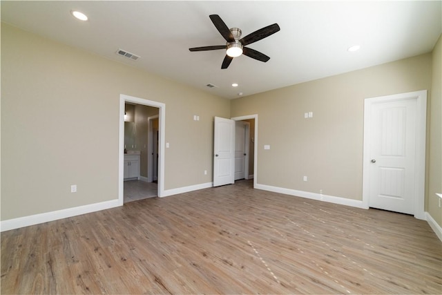 unfurnished bedroom with connected bathroom, light hardwood / wood-style flooring, and ceiling fan