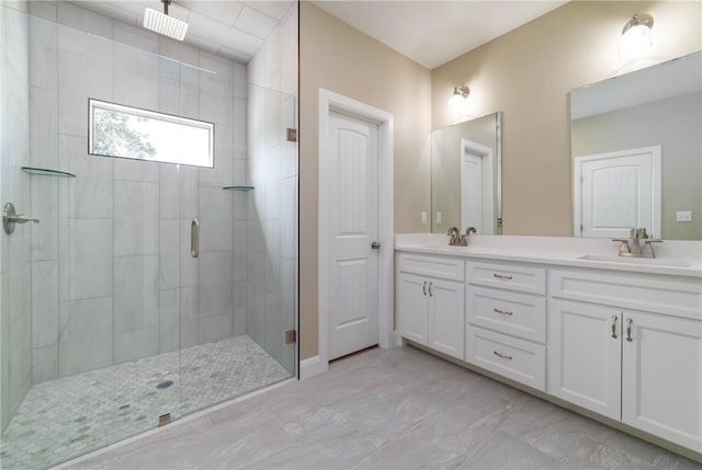 bathroom with vanity and a shower with shower door