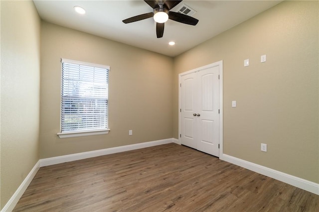 empty room featuring ceiling fan and hardwood / wood-style flooring